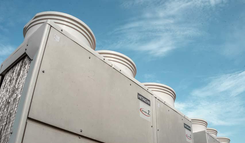 Low-angle perspective of Hitachi Set Free Sigma VRF outdoor units against blue sky
