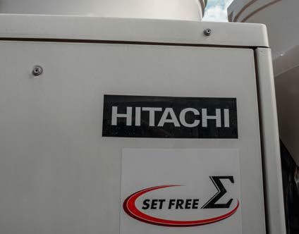 Close-up of the Hitachi Set Free Sigma badge on a VRF outdoor unit at Mall of Gulberg