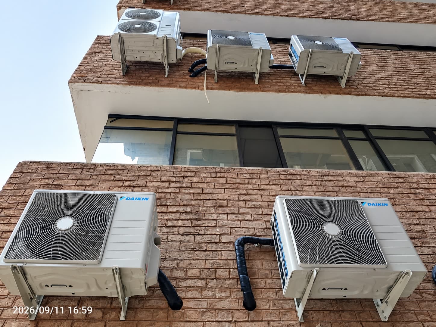Daikin outdoor units on a brick ledge at Kohat Institute of Medical Sciences