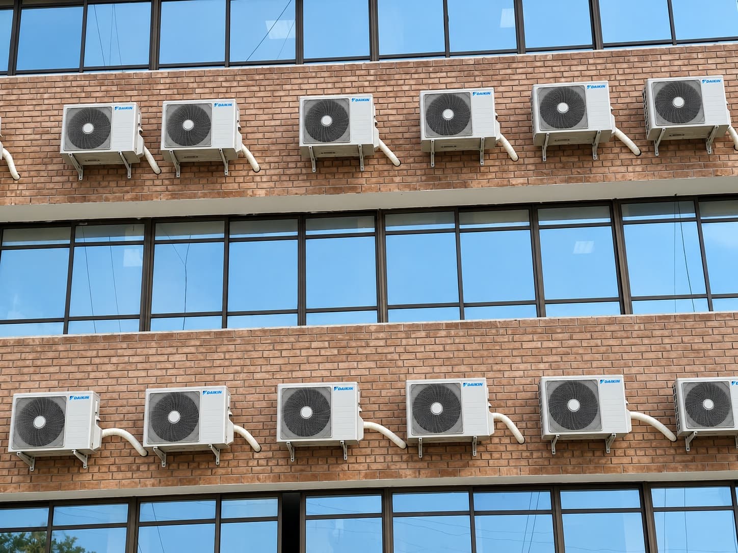 Outdoor units mounted between the window bands at Kohat Institute of Medical Sciences