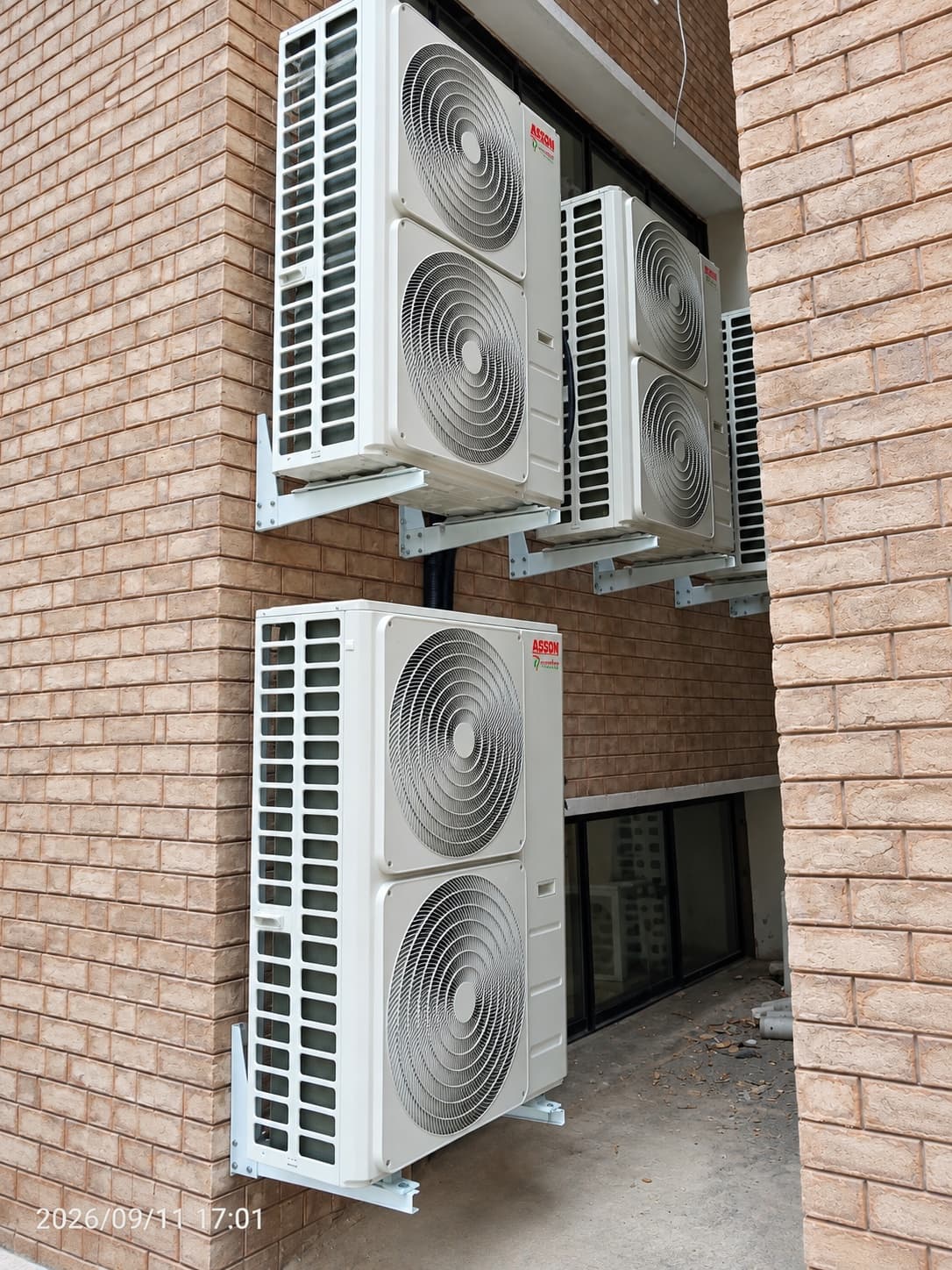 Outdoor condensing units wall-mounted in a building recess at Kohat Institute of Medical Sciences