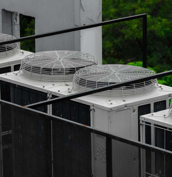Outdoor unit fans behind the rooftop safety railing at Quixel, Blue Area