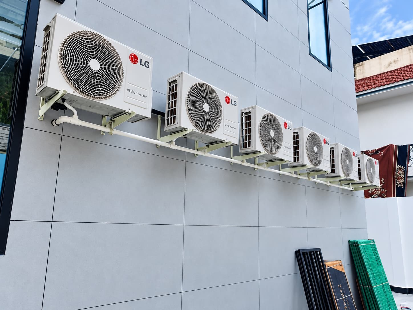 LG outdoor units bracketed along a residential facade