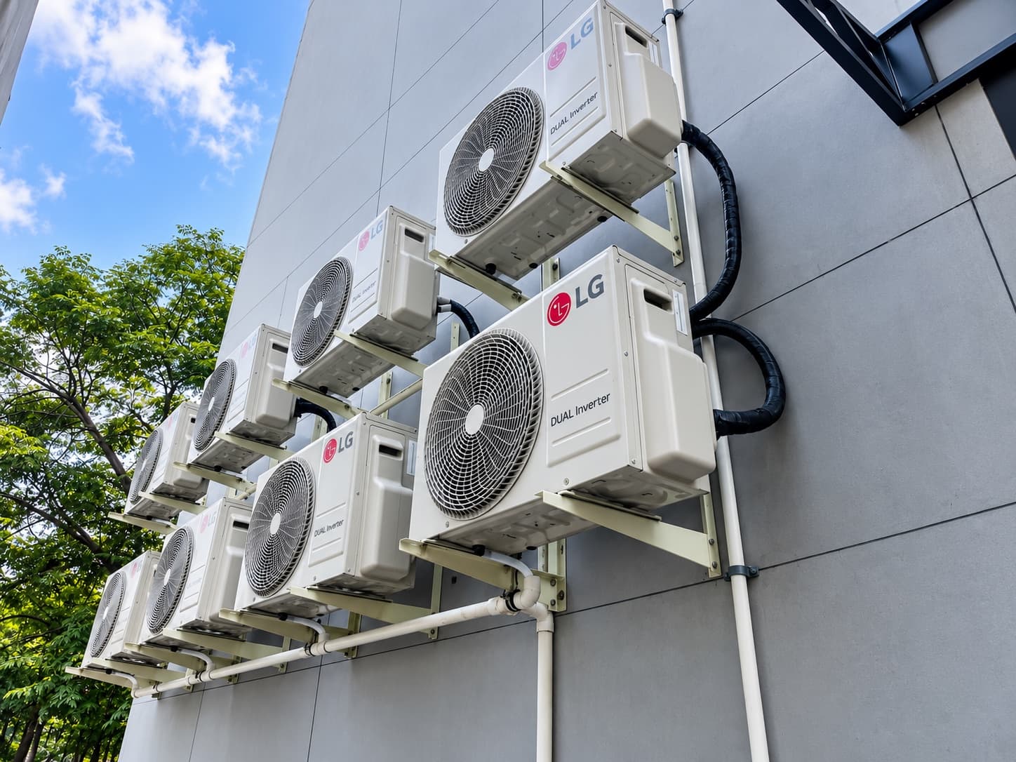 LG Dual Inverter outdoor units stacked on brackets up a residential wall